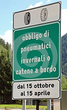 Italian traffic sign with text that means obligation of winter t photo