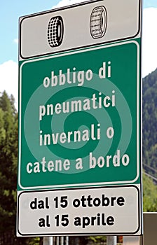 Italian traffic sign with text that means obligation of winter t photo