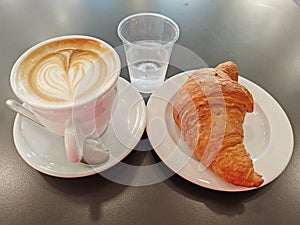 Italian typical breakfast. Cappuccino and croassant