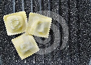 Italian uncooked ravioli on table