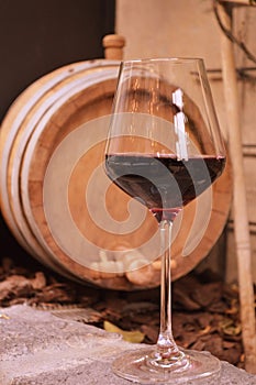 Italian wineglass red and wine cask on background in restaurant