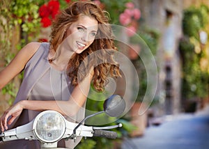 Italian woman sitting on a italian scooter