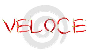 Italian word veloce meaning quick written with red chili peppers on white background abstract concept photo photo