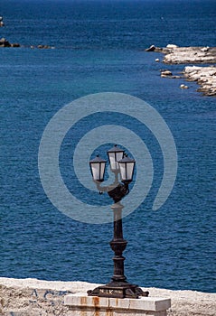 Italy.  Bari. The Lungomare.  View with a three-light lamppost facing the Adriatic Sea