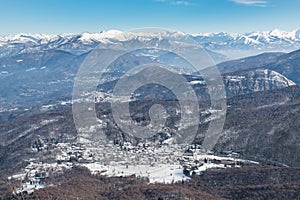 Italy. Campo dei Fiori Regional Park in the foreground, with Brinzio village, in the background the Alpine chain photo