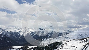 Italy, Dolomites, Canazei, The flying soaring drone hanged over mountains, on a background snow-covered mountains, the