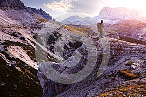 Italy, Dolomites - Male hiker standing on the barren rocks photo