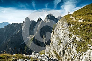 Italy, Dolomites - Man hiker standing very far from the edge of the barren rocks