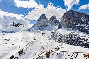 Italy, Dolomites, Trentino, The flying soaring drone hanged over mountains, on a background snow-covered mountains, the