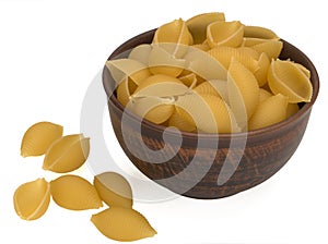 Italy dry raw pasta conchiglie in a bowl and on white background