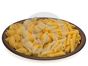 Italy dry raw pasta penne rigate and conchiglie on the plate