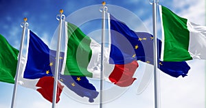 Italy and European Union flags waving on a clear day