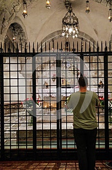 Italy. Faith and Religion. Bari. Basilica of San Nicola. A man prays in front of the chapel with the relics of the saint in cripta