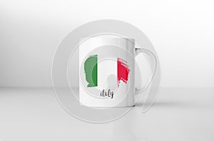 Italy flag on white coffee mug.