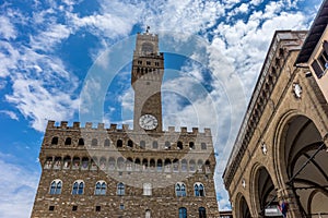 Italy,Florence, Palazzo Vecchio, a large tall tower with a clock on the side of Palazzo Vecchio