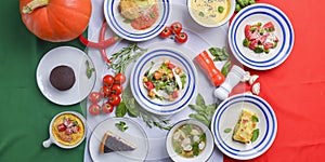 Italy food, dishes of Italian cuisine served over Italian flag. vegetable salad, soup. Seasonal autumn menu