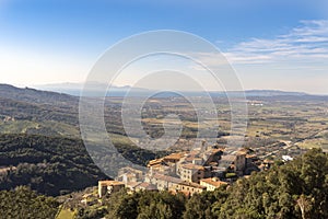 Italy Grosseto Maremma, route in MTB and EMTB in the woods of Gavorrano up to Mount Calvo, panoramic view of the village and the