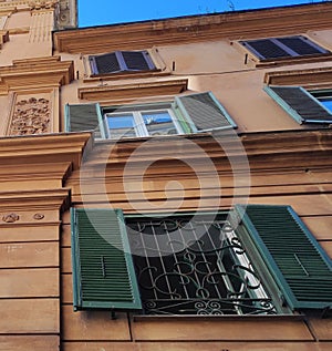 Italy, historic city architecture. A building with the characteristic facade and windows in Rome.