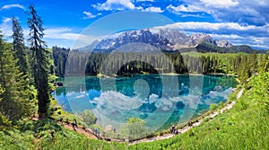 Italy Idyllic nature scenery- trasparent mountain lake Carezza surrounded by Dolomites photo