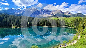 Italy Idyllic nature scenery- trasparent mountain lake Carezza surrounded by Dolomites photo