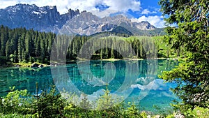 Italy Idyllic nature scenery- trasparent mountain lake Carezza surrounded by Dolomites photo