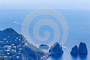 Italy. Island Capri. Faraglioni rocks and boats from Monte Solar