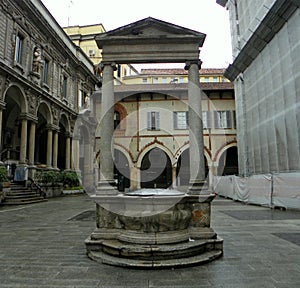 Italy, Milan, Piazza Mercanti (Merchants Square), well 16th century with two columns and entablature photo