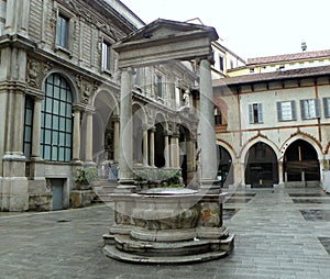 Italy, Milan, Piazza Mercanti (Merchants Square), well 16th century with two columns and entablature photo