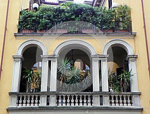 Italy, Milan, 2 Via Moneta, two-storey balcony with plants photo