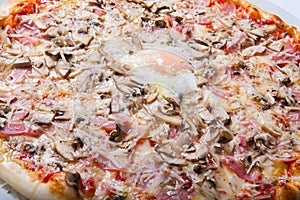 Italy pizza with egg yolk ham mushrooms on a white background