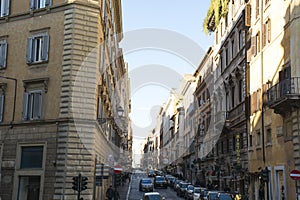 Italy, Rome - December 10, 2018. Street of Rome, italian buildings people and cars at sunny day. Daily life of Rome