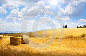 Italy summer or autumn golden countryside landscape, Wheat Straw Bales and farmland over sunset sky