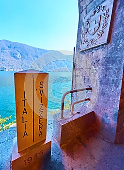 Italy-Switzerland border pole against the Lake Lugano
