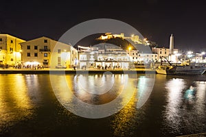 Italy, Tuscany Maremma Castiglione della Pescaia, fireworks over the sea, panoramic night view of the port and the castle