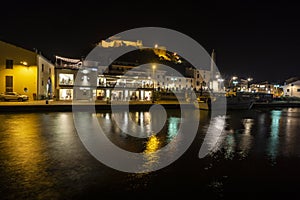 Italy, Tuscany Maremma Castiglione della Pescaia, fireworks over the sea, panoramic night view of the port and the castle