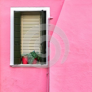 Italy, Venice, Burano island. Traditional colorful walls and windows of the old houses.