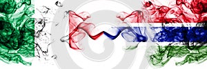 Italy vs Gambia, Gambian smoky mystic flags placed side by side. Thick colored silky abstract smoke flags