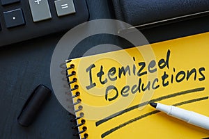 Itemized deductions handwritten note in a yellow notepad.