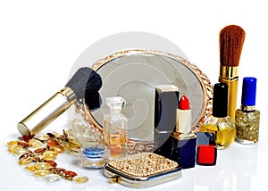 Items for decorative cosmetics, makeup, mirror and flowers