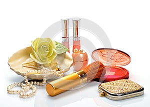 Items for decorative cosmetics, makeup, mirror and flowers