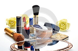 Items for decorative cosmetics, makeup, mirror and flowers