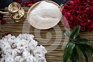 Items for the Indian Yajna ritual. garland of white flowers, red rose petals and copper dish with rice for Hindu Vedic