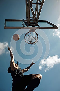 Its all about agility. a sporty young man playing basketball on a sports court.