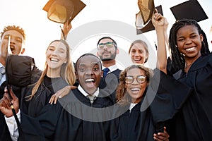 Its all cheers and smiles today. Portrait of a group of university students celebrating their graduation.