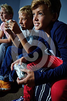 Its all fun and gaming. young boys playing video games.