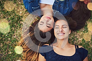 Its always all smiles when were together. High angle shot of two female best friends spending the day in a public park.