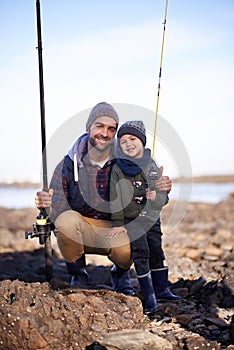 Its bonding time. Portrait of a loving father and son fishing by the sea.