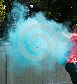 Its a boy blue smoke from a baseball hit by father in pink shirt