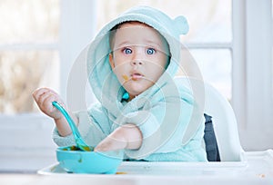 Its so delicious that I want to lick the bowl clean. Shot of an adorable baby boy eating his food.