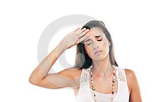 Its a drama queen thing. Studio shot of a young woman feeling unwell against a white background.